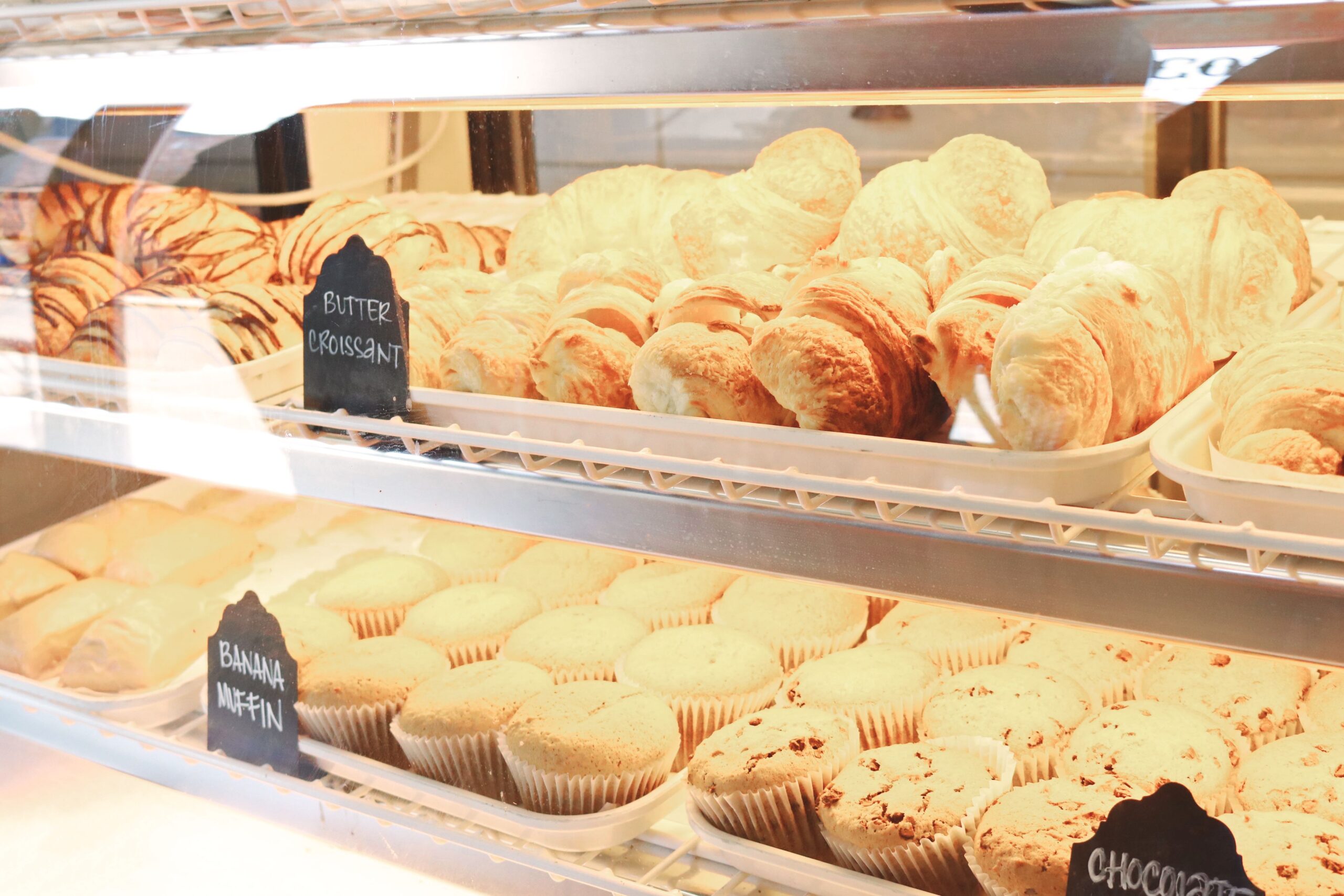 A tempting display of croissants and muffins fresh from the bakery, ready to enjoy.